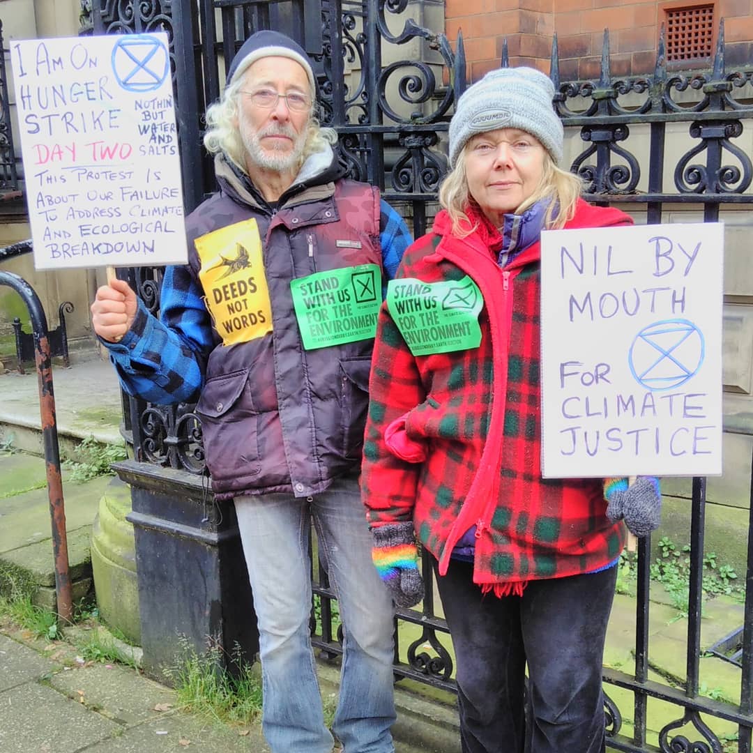 Anthony and Mary on Hunger Strike with signs saying so